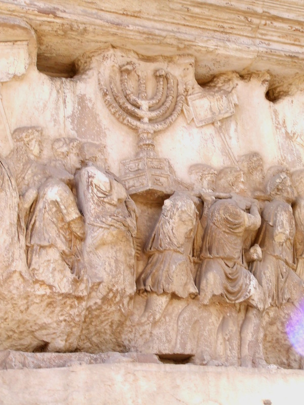 Carrying_off_the_Menorah_from_the_Temple_in_Jerusalem_depicted_on_a_frieze_on_the_Arch_of_Titus_in_the_Forum_Romanum.JPG