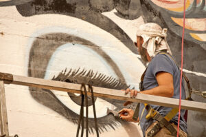 Portland artist Dan Cohen updating the mural.