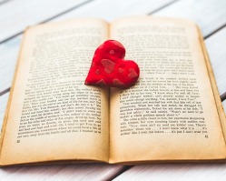 red heart paperweight holding open a book